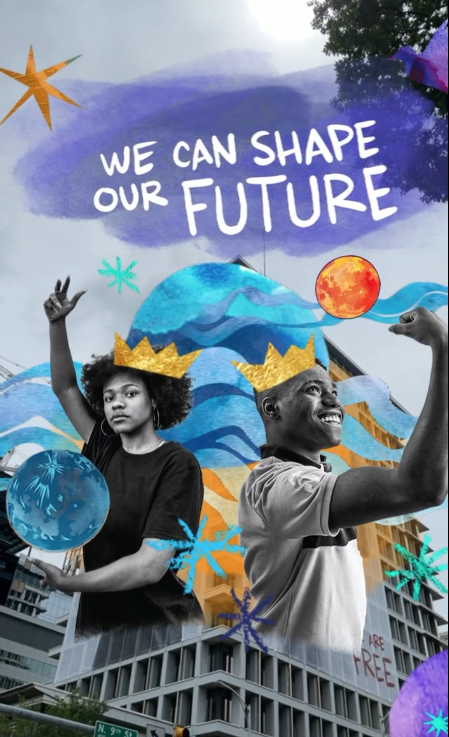 Two people pose on the side of a building wearing crowns and holding planets, above them is text that reads,