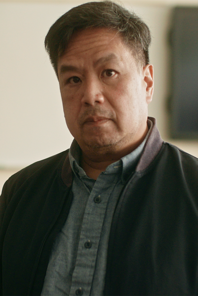 Truong Tran looking at the camera in a classroom