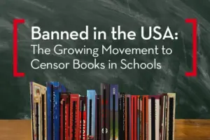 A collection of books stands upright in front of a chalkboard that reads, Banned in the USA: The Growing Movement to Censor Banned Books in Schools.
