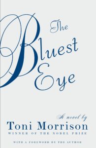 The book cover of The Bluest Eye by Toni Morrison features elegant blue script on a white background, marking its inclusion on the Pen America Centenary Reading List, with ornate title lettering and a note of Morrison as Nobel Prize-winning author.