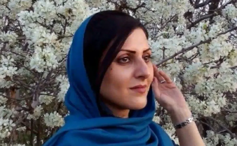 A woman wearing a blue head scarf, reminiscent of the resilience highlighted in the Freedom to Write Index 2020.