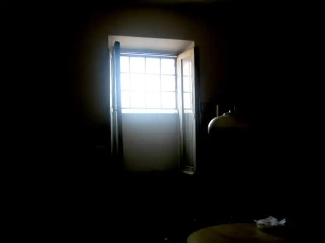 A bright window lets sunlight into a dark room, illuminating part of the wall and contrasting sharply with the surrounding shadows—much like Liu Xiaobo’s words bringing light to darkness.