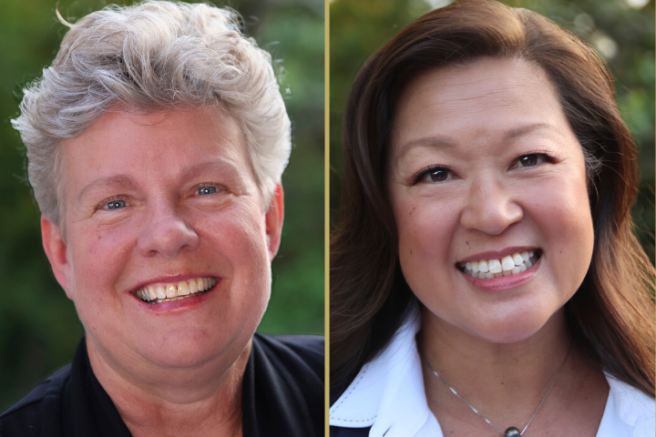 Side-by-side portraits of two women smiling outdoors, one with short, curly gray hair and the other with long, straight brown hair, both wearing dark tops against a blurred green background.