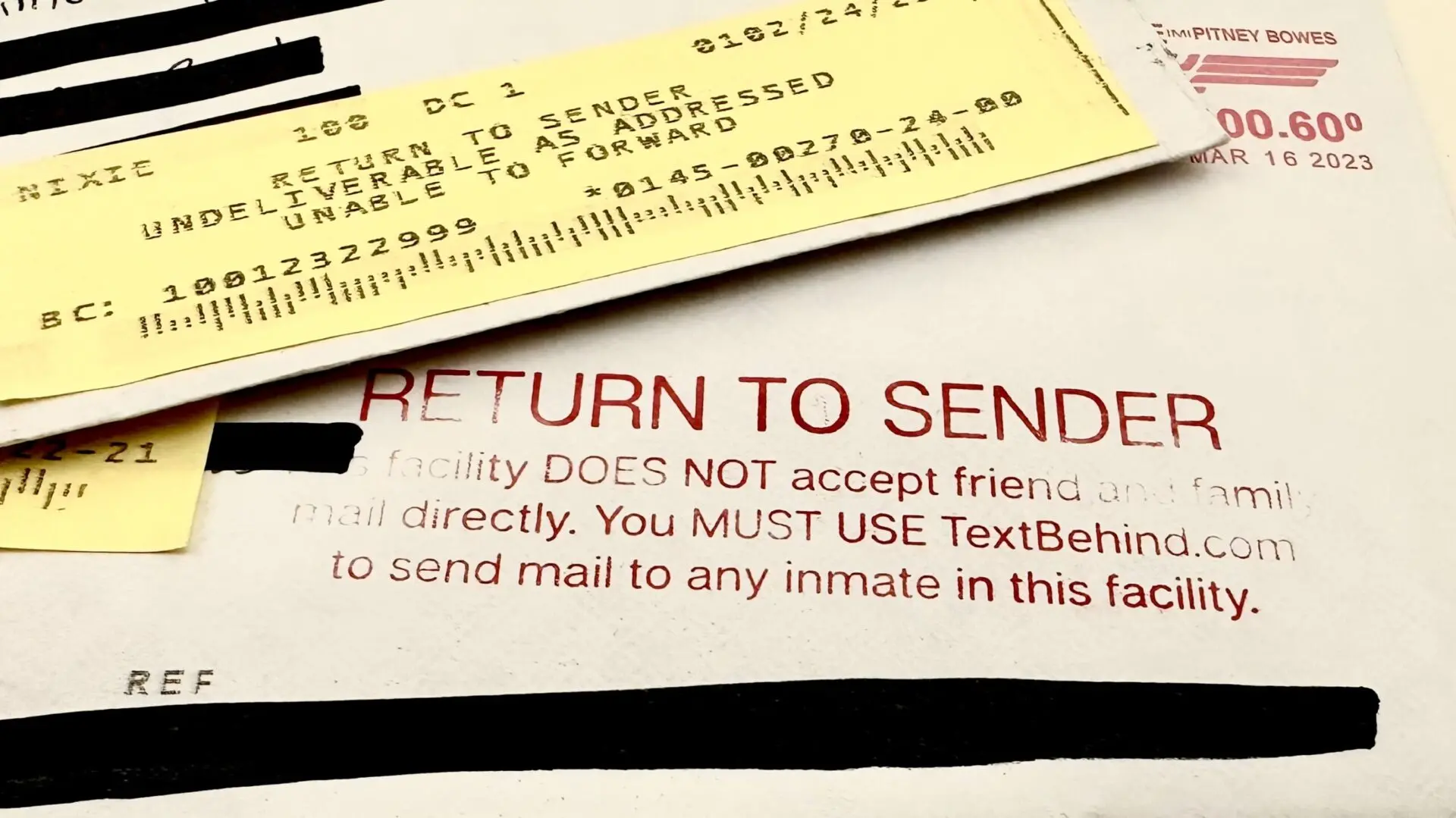 A close-up of two returned mail labels. The top yellow label reads RETURN TO SENDER, UNABLE TO FORWARD. The larger white envelope beneath shows RETURN TO SENDER in red text and instructions for sending mail to inmates.