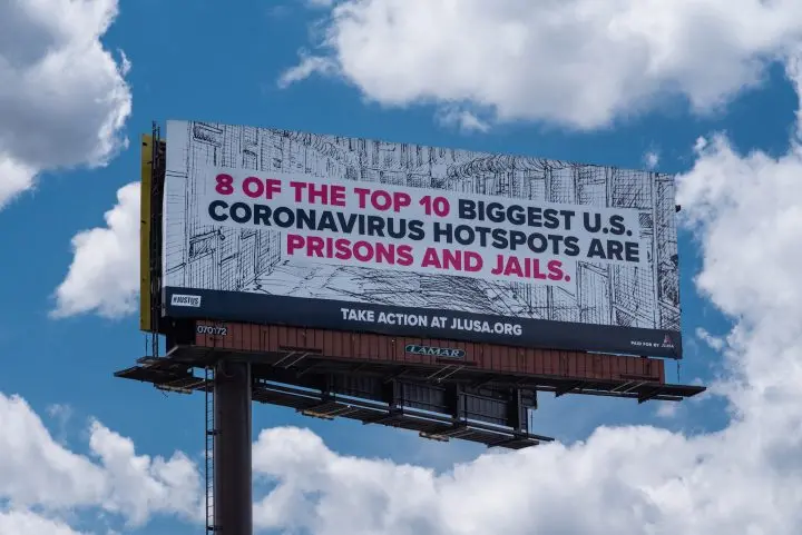 Billboard that reads: “8 of the top 10 biggest U.S. coronavirus hotspots are prisons and jails.”