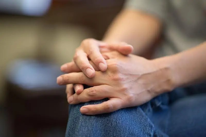 Louise Waakaa'igan's hands resting on her knee