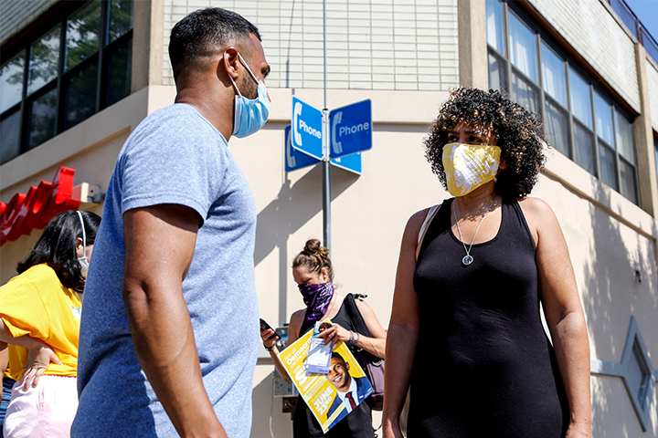 Dianne Morales speaking to a constituent on the street
