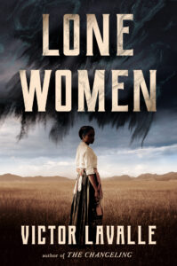 Book cover for Lone Women by Victor LaValle, featuring a Black woman in historical clothing standing in a wide, grassy field with mountains behind her and dark, swirling clouds overhead—perfect for fans of any Victor LaValle interview.