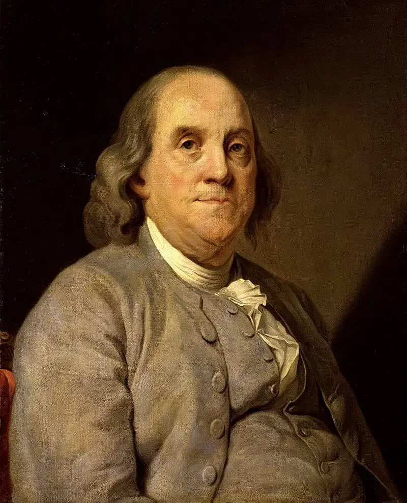 A classic portrait of an older man with long, gray hair wearing a plain, gray coat and a white cravat. He looks directly at the viewer with a slight, thoughtful expression, set against a dark background.