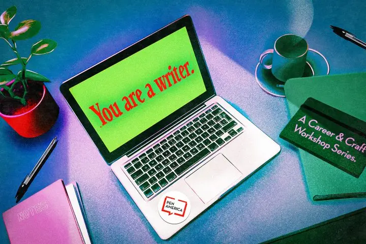 A laptop displaying the message You are a writer. sits on a desk with a plant, a pen, notebooks, and a folder labeled A Career & Craft Workshop Series. A PEN America sticker is on the laptop.