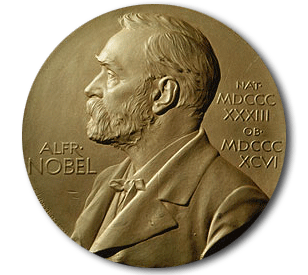 A gold Nobel Prize medal shows a left-facing profile of Alfred Nobel with his name and Roman numerals engraved beside him on a textured background.