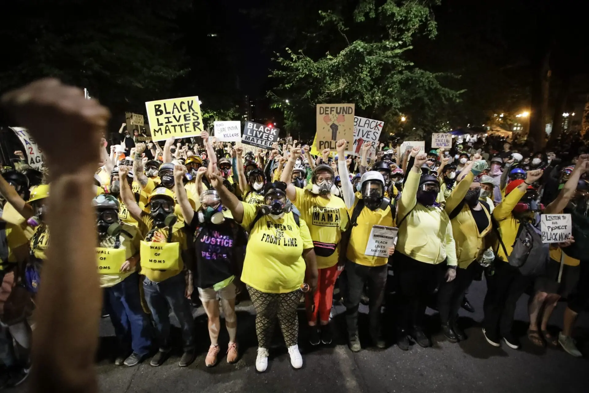 In this July 28, 2020, file photo, the “Wall of Moms” protest group marches with other demonstrators during a Black Lives Matter protest at a courthouse in Portland, Ore. (AP Photo/Marcio Jose Sanchez, File)