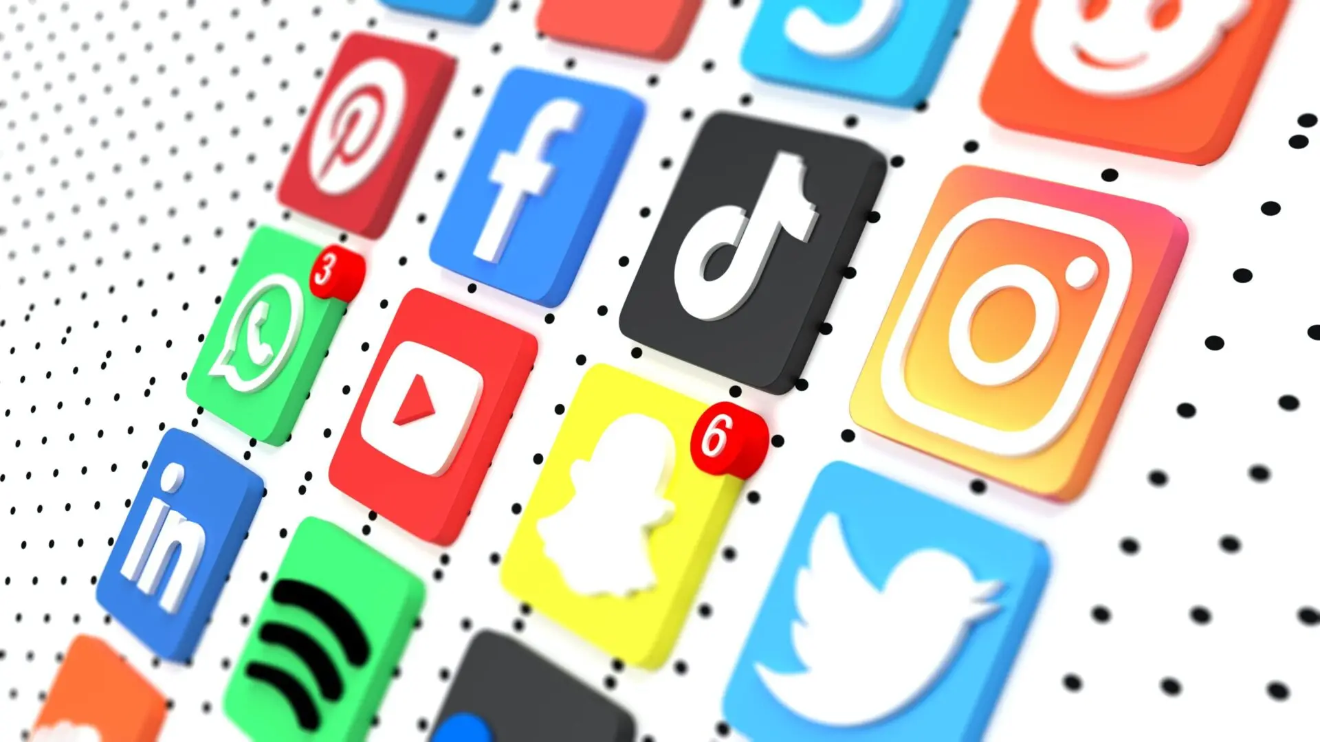 A 3D grid of popular social media app icons, including Facebook, Instagram, TikTok, Snapchat, Twitter, YouTube, Spotify, and Pinterest, some with red notification badges.