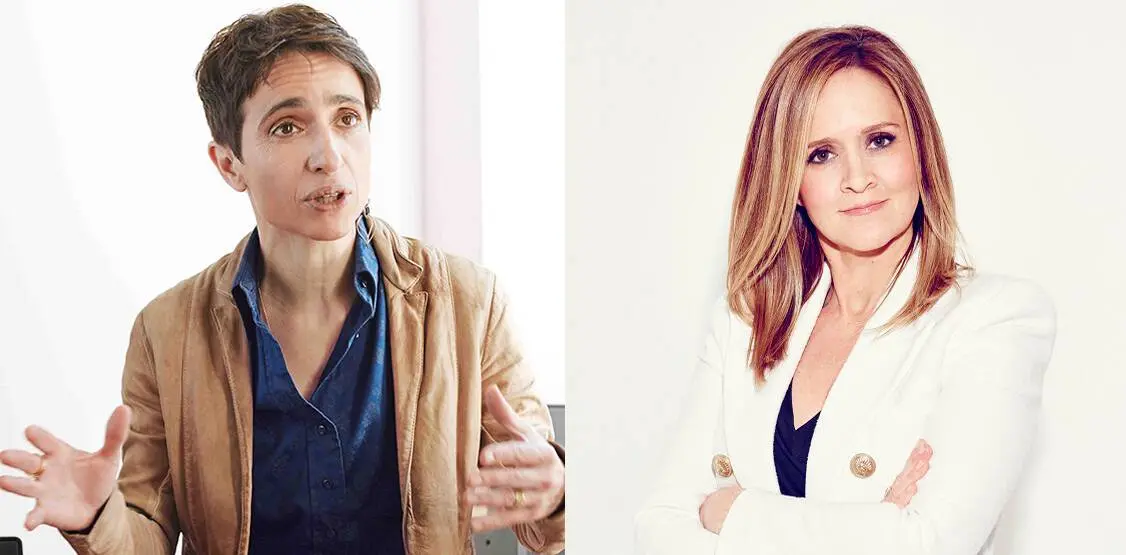 Two women are side by side. The woman on the left has short dark hair and wears a tan jacket over a blue shirt, gesturing with her hands. The woman on the right has straight light hair and wears a white blazer, arms crossed.