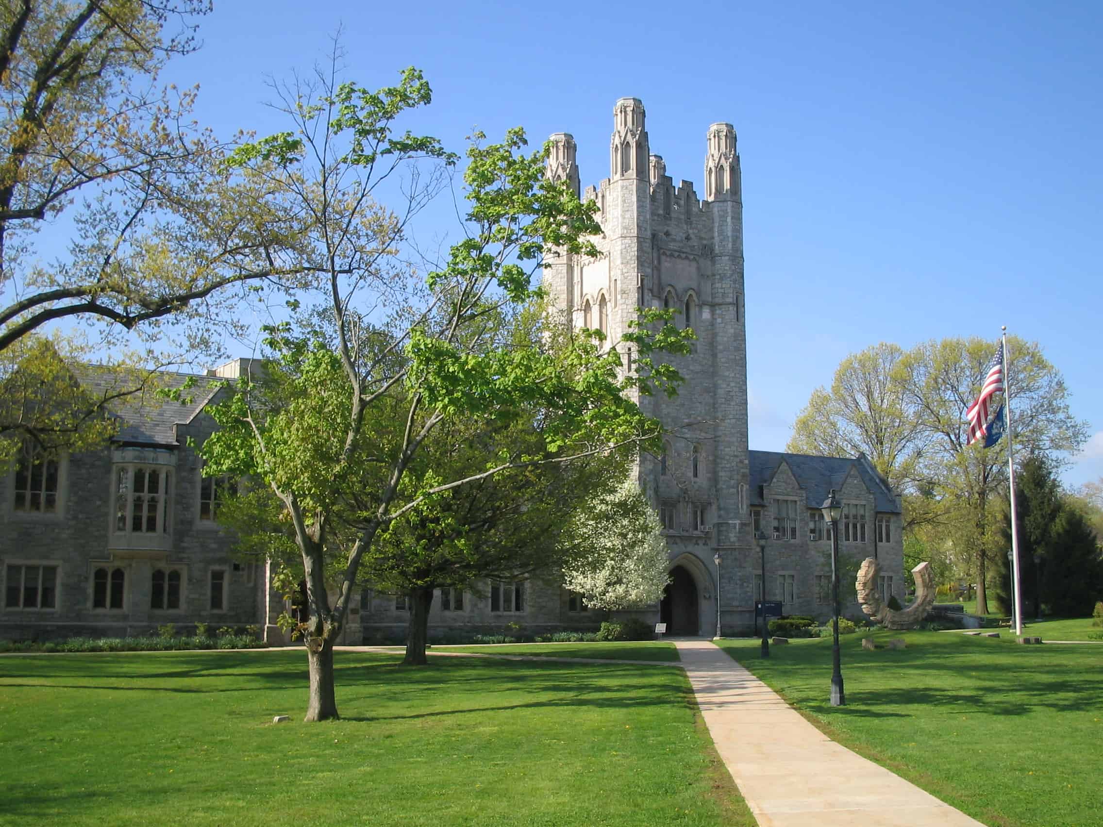 A stone building with trees and grass.