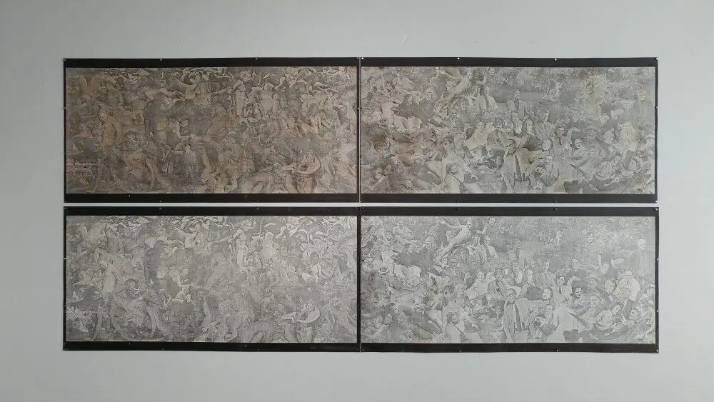 Four large, rectangular grayscale panels are mounted on a wall, each filled with intricate, chaotic scenes of people in various poses, evoking a sense of movement and crowd dynamics.