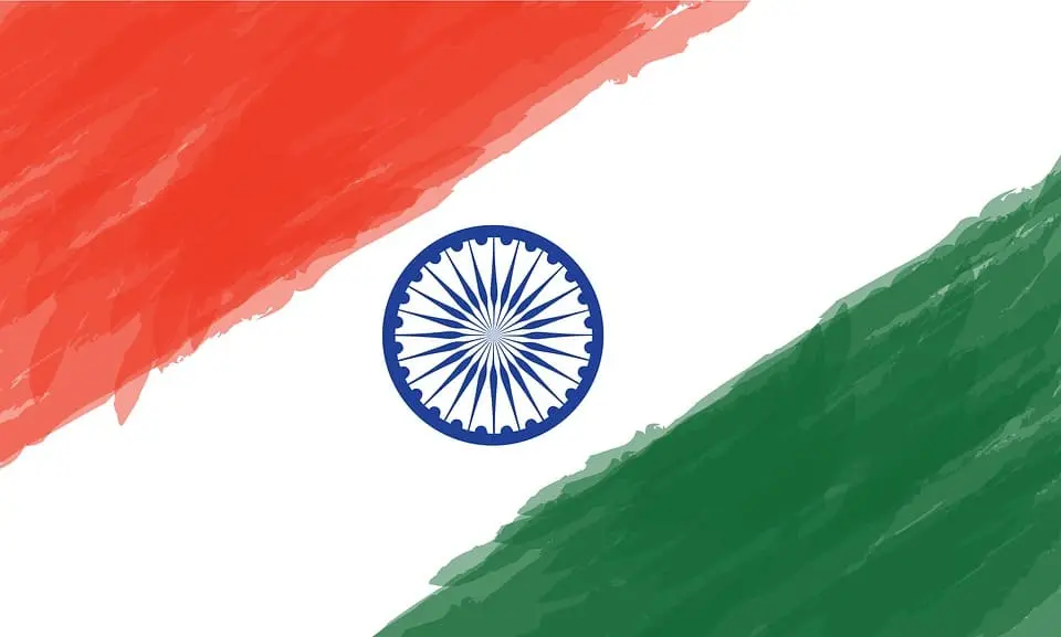 Abstract illustration of the Indian flag with a saffron brushstroke on top, a green brushstroke at the bottom, and a blue Ashoka Chakra wheel in the center on a white background.