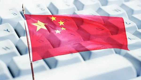 A Chinese flag is superimposed over a white computer keyboard, symbolizing Chinas presence or influence in technology or the internet.