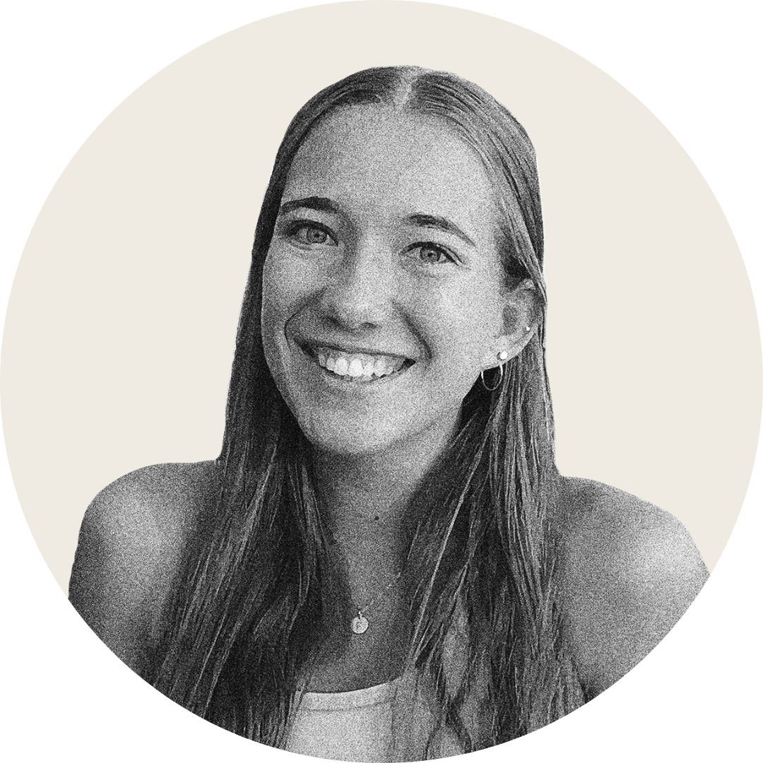 A young woman with long straight hair smiles at the camera. She is wearing a sleeveless top, small hoop earrings, and a necklace. The image has a neutral circular background and a grayscale, textured effect.