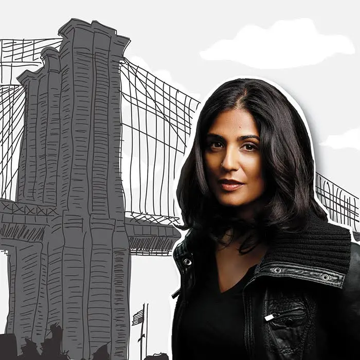 A woman with dark hair wearing a black jacket stands in front of an illustrated background of the Brooklyn Bridge, representing the spirit of the Emerging Voices Fellowship.