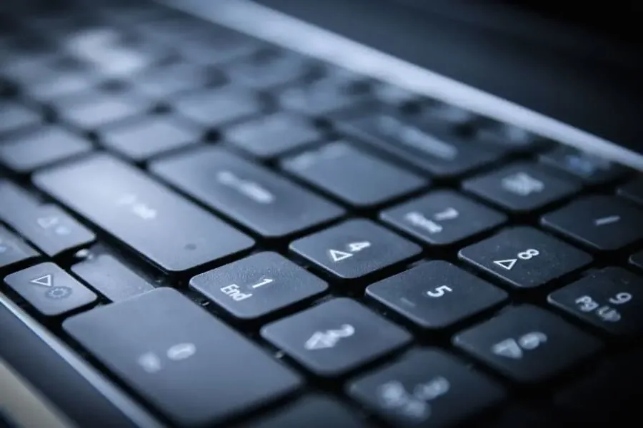 Close-up view of a black computer keyboard with keys in focus, including letters, numbers, and special function symbols—perfect for exploring topics like Banned Books Week 2024 or researching digital resources. The image highlights the texture and layout of the keys.