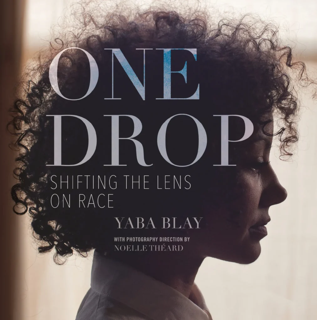 A side-profile of a woman with curly hair is shown in soft lighting. Overlaid text reads: ONE DROP: Shifting the Lens on Race. Yaba Blay. With photography direction by Noelle Theard and featured by PEN America Reading Between the Lines.