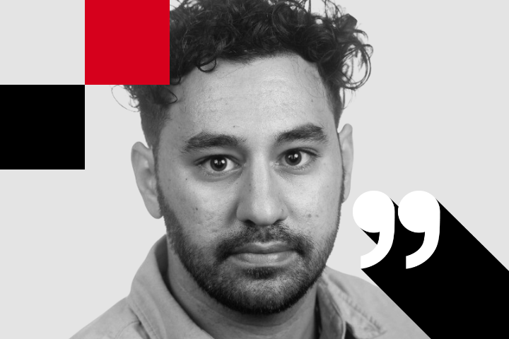 Man with curly hair and a beard, reminiscent of Joseph Gedeon, looking directly at the camera against a grayscale background with red and black geometric shapes. A large quotation mark is prominently featured on the side.