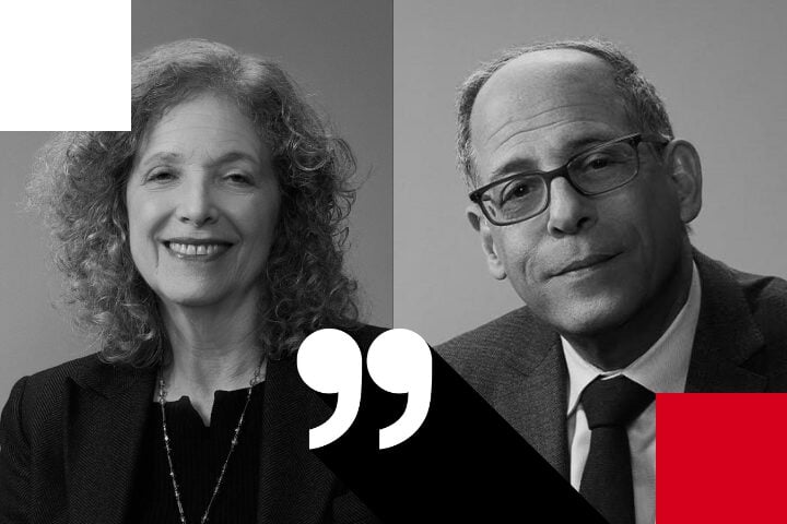 Two people in black and white portraits side by side. The person on the left has curly hair and is smiling. The person on the right has glasses and a serious expression. A large quotation mark symbol overlays the image in the center.