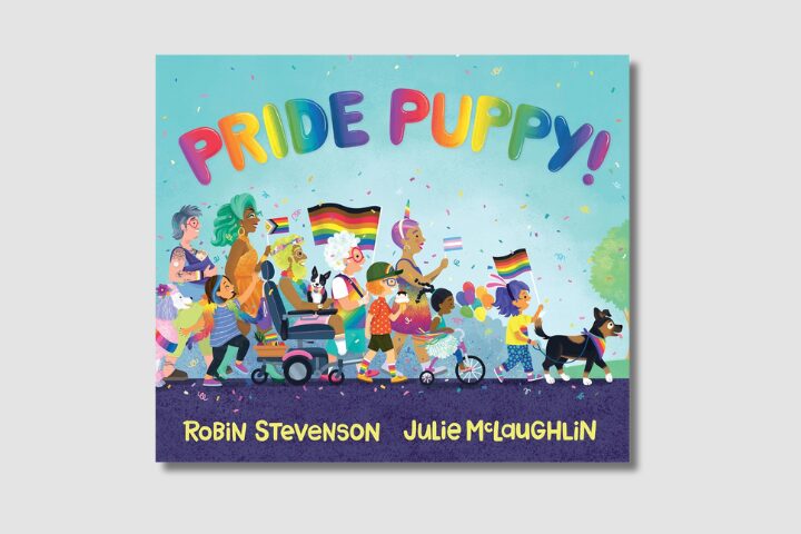 Illustrated book cover titled Pride Puppy! shows a diverse group of people and children marching in a pride parade with rainbow and pride flags, balloons, and a dog leading the way. Authors: Robin Stevenson, Julie McLaughlin.