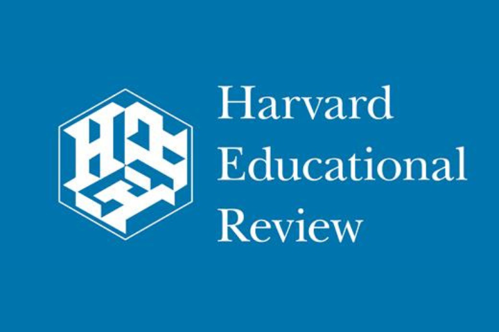 White text on a blue background reads Harvard Educational Review next to a white hexagon logo with stylized letters HER inside.