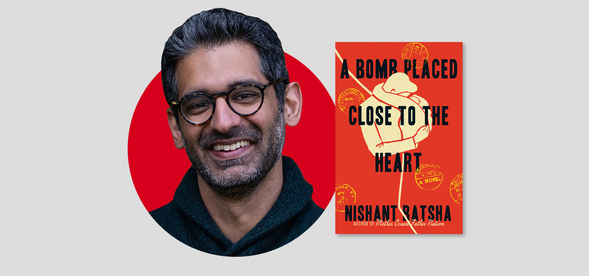 A smiling man with gray hair and glasses stands next to the cover of a book titled A Bomb Placed Close to the Heart by Nishant Batsha, featuring an image of a hand holding a string on a bright red background.