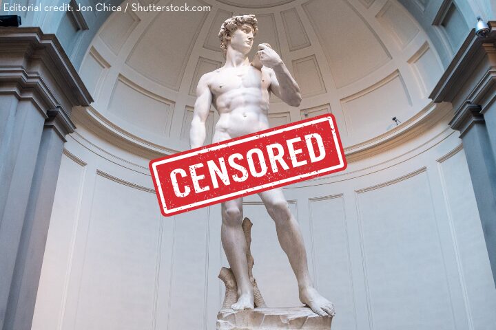 Michelangelos statue of David stands in a museum alcove. A red CENSORED stamp covers the lower part of the statue. Image credit is given to Jon Chica/Shutterstock.com in the top left corner.