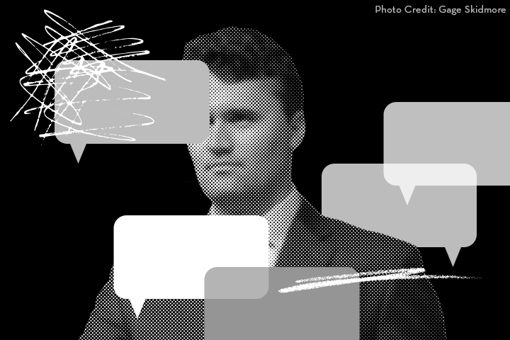 A grayscale image of a man in a suit with multiple semi-transparent speech bubbles and scribbles over his face. The background is black. “Photo Credit: Gage Skidmore” appears in the upper right corner.