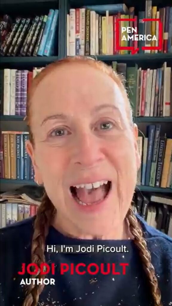A woman with red hair in braids smiles at the camera, standing in front of a bookshelf. The text reads “Hi, I’m Jodi Picoult” and identifies her as an author. The PEN America logo is in the top right corner.