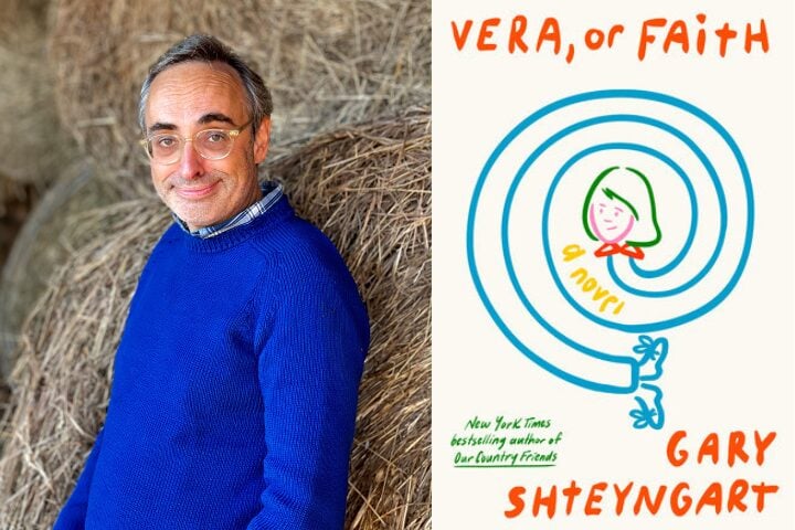 A man in glasses and a blue sweater stands in front of hay. Next to him is the cover of a book titled VERA, or FAITH: a novel by Gary Shteyngart, featuring a spiral with a woman’s face at the center.