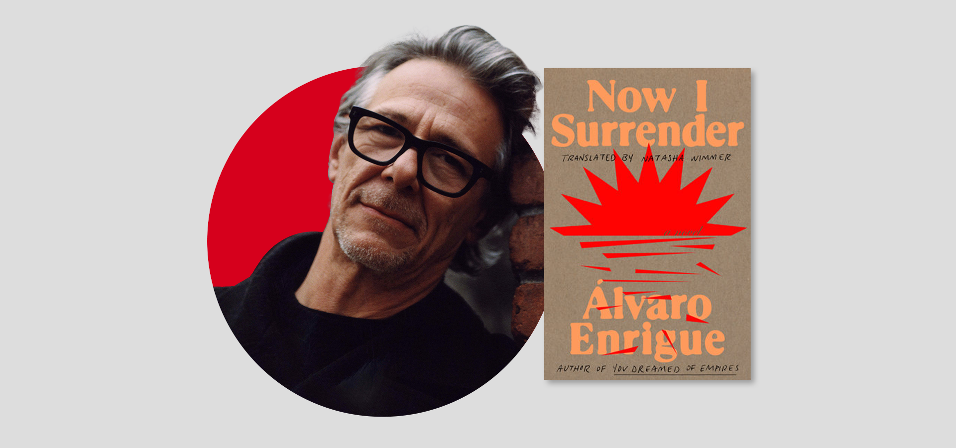 A man with gray hair, glasses, and a black jacket stands next to the book cover of Now I Surrender by Álvaro Enrigue, which features bold orange text and a stylized sun on a beige background.