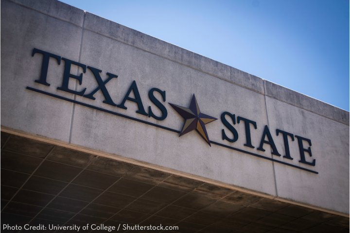 A concrete building facade features the words TEXAS STATE with a star between them, under a clear blue sky. Photo credit: University of College / Shutterstock.com.