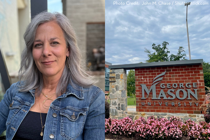 A woman with gray hair and a denim jacket smiles outdoors; beside her is a brick sign reading George Mason University with flowers and trees in the background.
