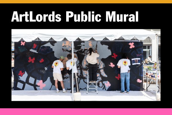 Four people work together to paint a public mural under a white canopy. The mural features abstract designs and pink flowers. A bold sign above reads, “ArtLords Public Mural.”.