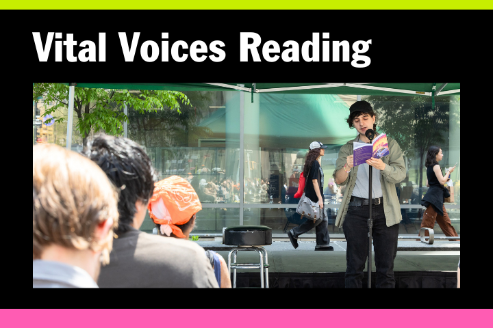 A person stands on an outdoor stage, reading from a book to an audience. The event banner above reads Vital Voices Reading. People and trees are visible in the background.